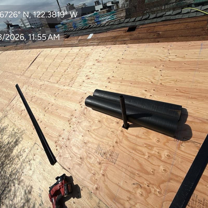 Plywood roof decking with ventilation pipe and tools