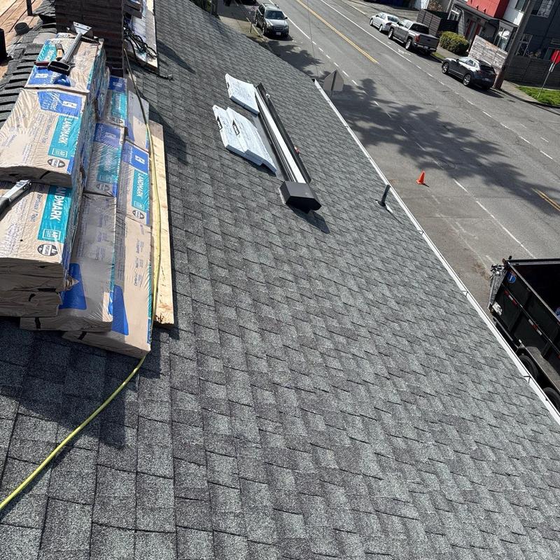 Asphalt shingle roof with new materials staged for installation