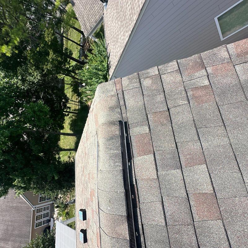 Asphalt shingle roof with ridge vent and hail damage inspection