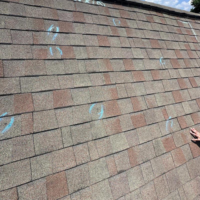 Asphalt roof shingles with hail damage markings
