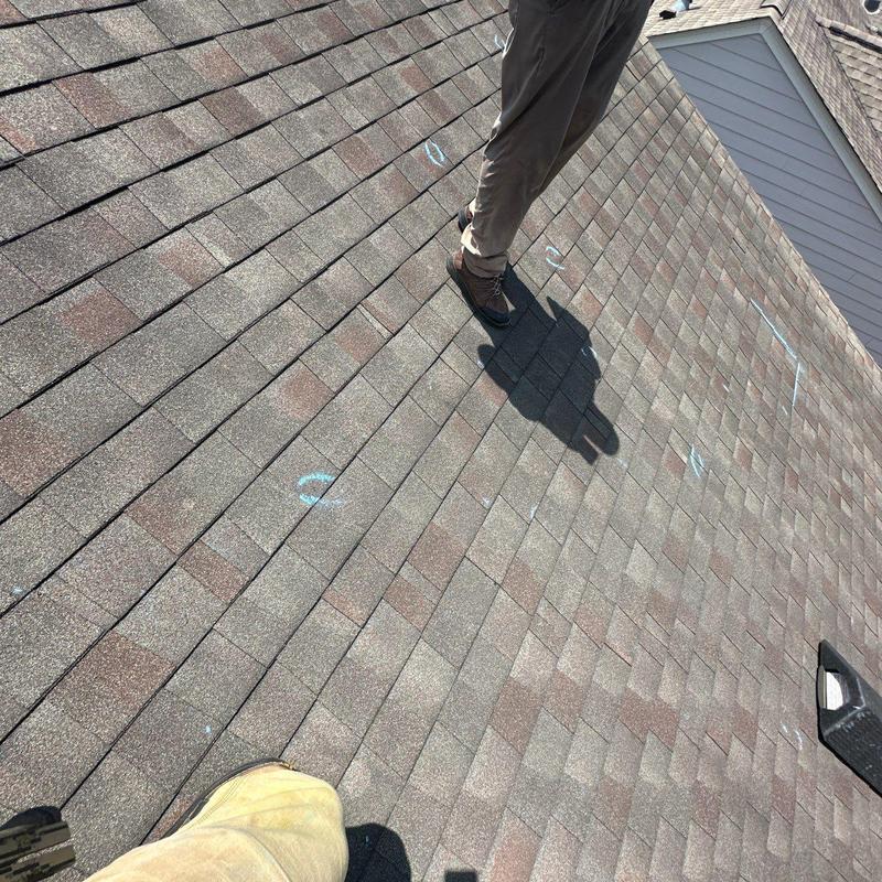 Roof shingles with marked hail damage on roof surface