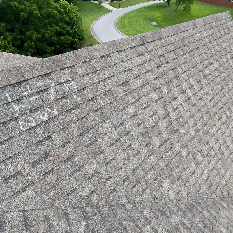 Asphalt shingle roof with chalk hail damage markings