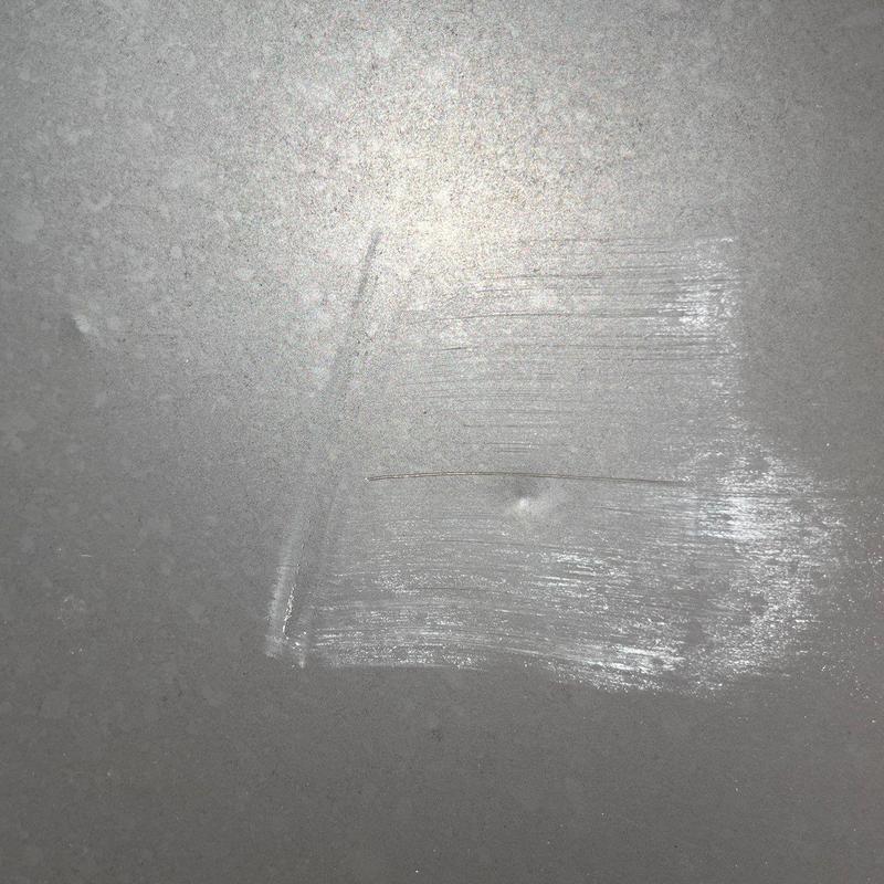 Roof shingle hail damage with impact marks and scratches