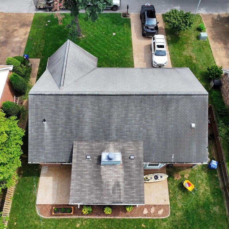 Asphalt shingle roof with visible wear and markings
