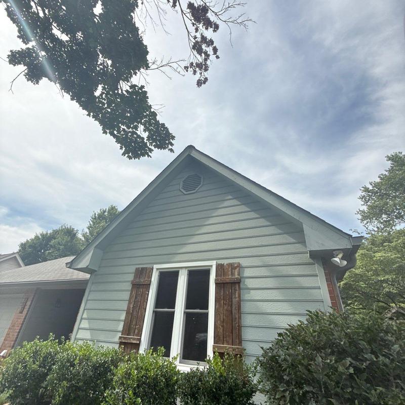Roof shingles and ventilation inspection on house gable