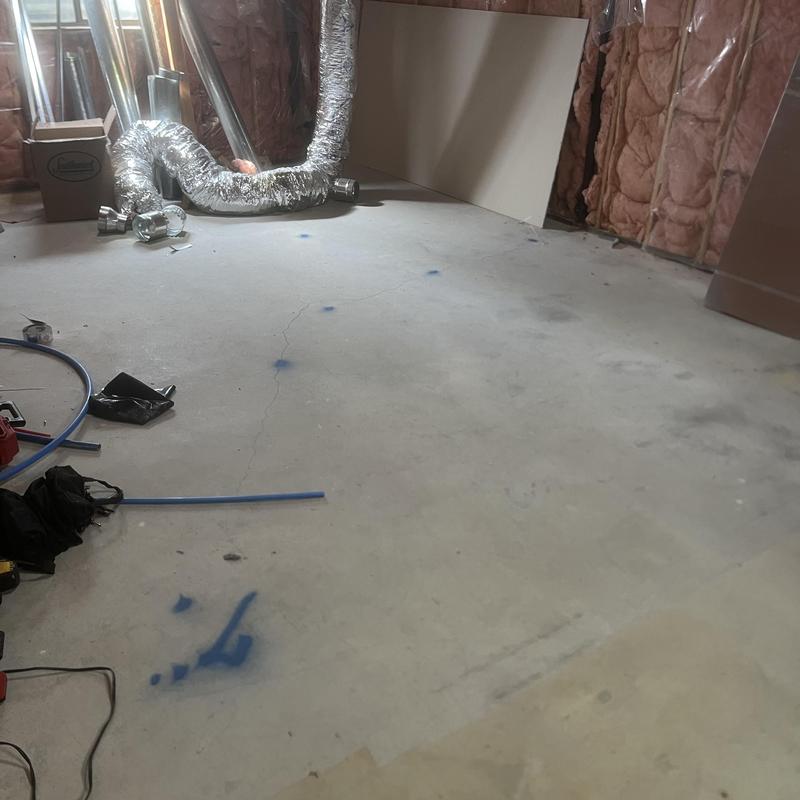 Sewer line locate markings on basement slab floor