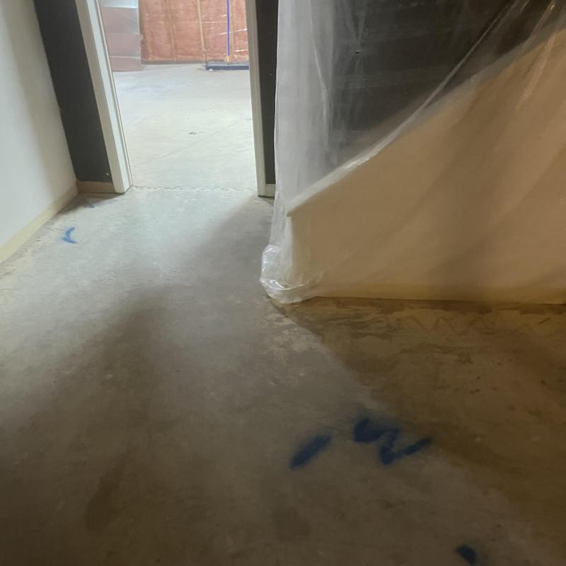 Sewer line markings on basement concrete floor