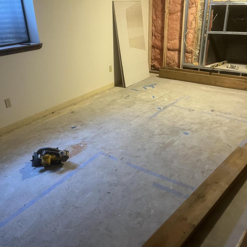 Sewer line location markings on basement slab floor