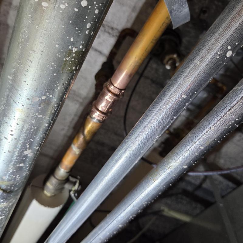 Copper water pipe with repair fitting in ceiling space