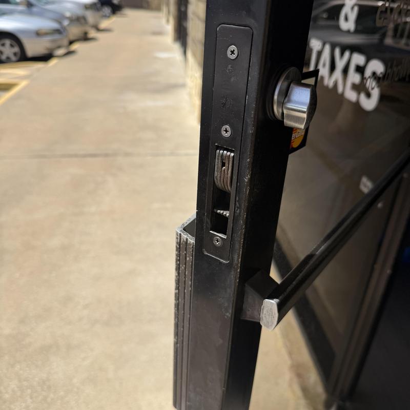 Inside thumb turn lock cylinder on storefront door