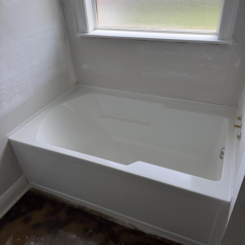 Acrylic bathtub installed near window in bathroom