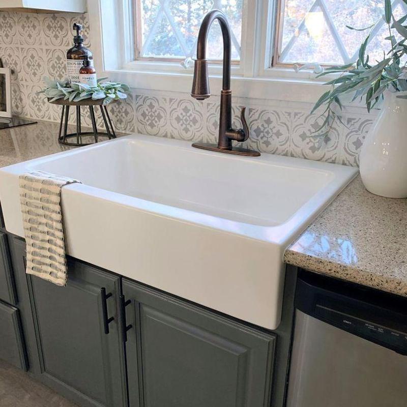 Farmhouse kitchen sink with bronze faucet and countertop