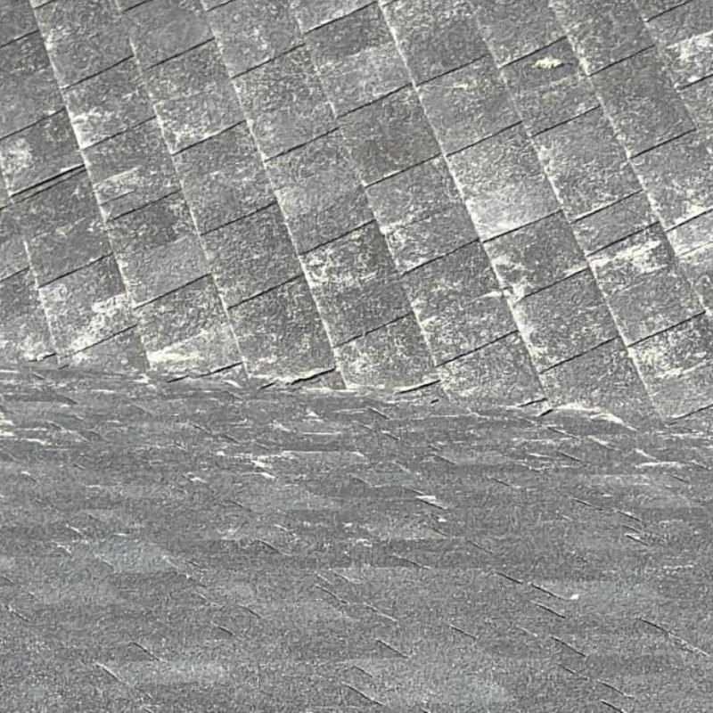 Asphalt shingle roof with weathering marks