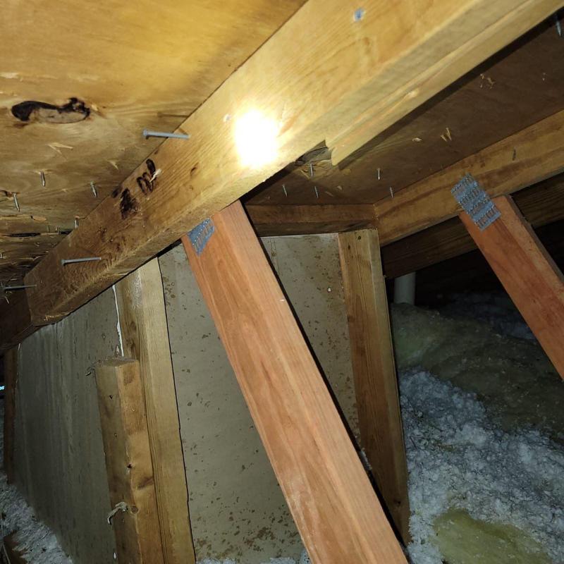Wooden roof trusses with damaged structural supports
