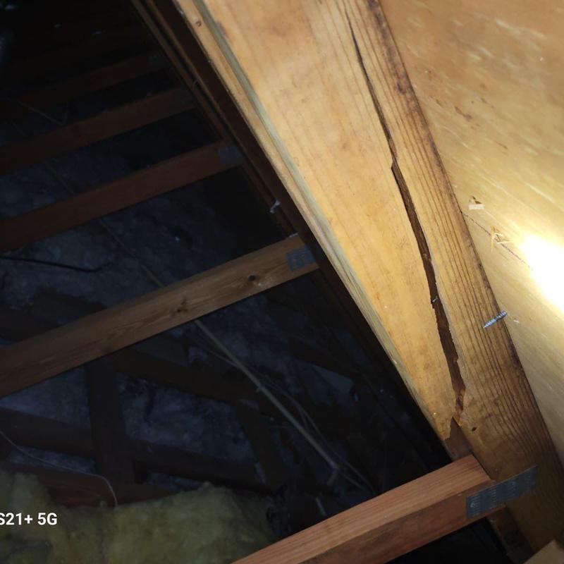 Wooden roof truss with visible structural damage