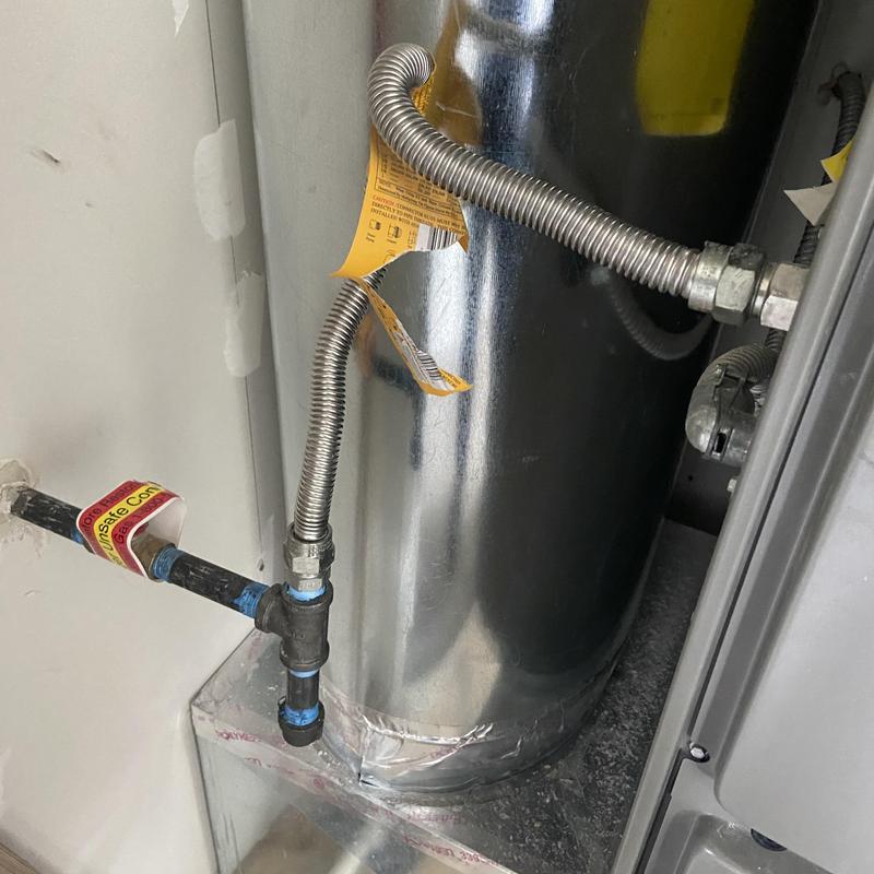 Flexible gas line and furnace connection with warning tag Flexible gas line and furnace connection with warning tag