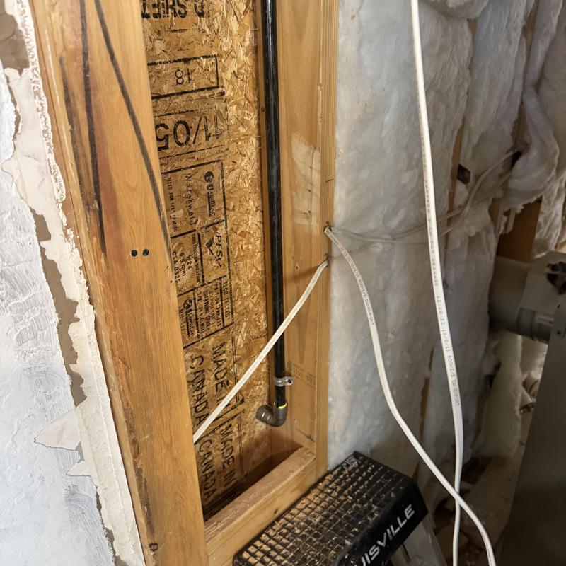 Gas line inside wall with insulation and wiring