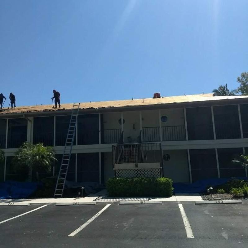 Shingle roof tear-off on two-story condo building