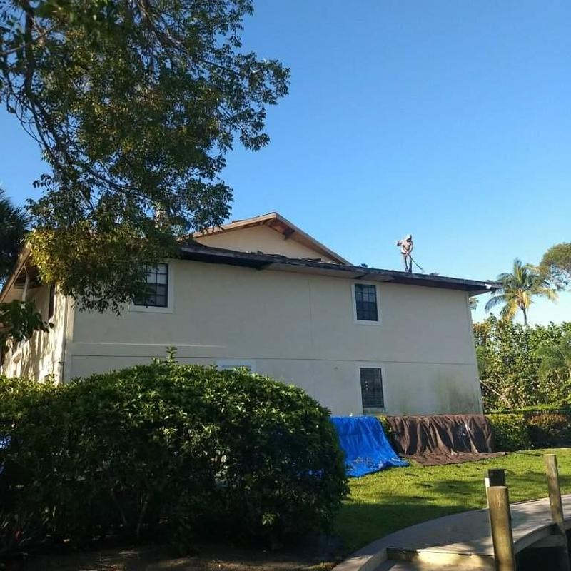 Shingle roof tear-off on Naples condo with safety measures