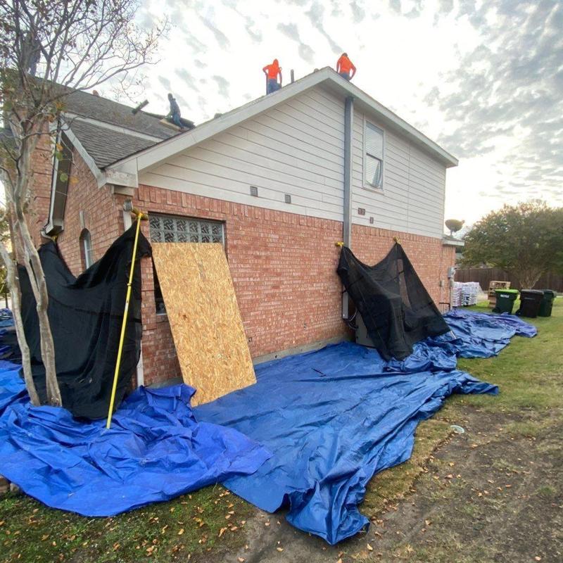 GAF Timberline shingle roof with protective tarps and screens GAF Timberline shingle roof with protective tarps and screens