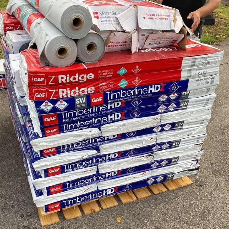 Roofing shingles and underlayment stacked on pallet Roofing shingles and underlayment stacked on pallet