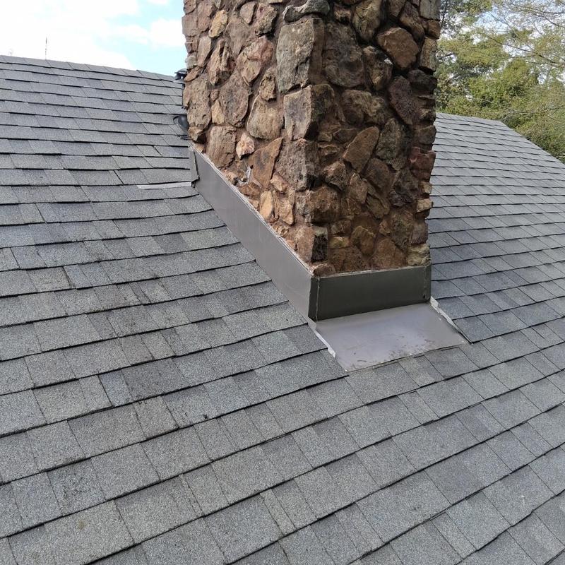 Chimney flashing installation on asphalt shingle roof