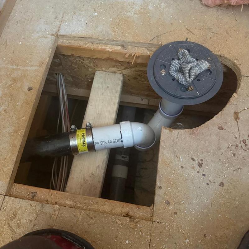 Bathroom floor drain piping installation under subfloor