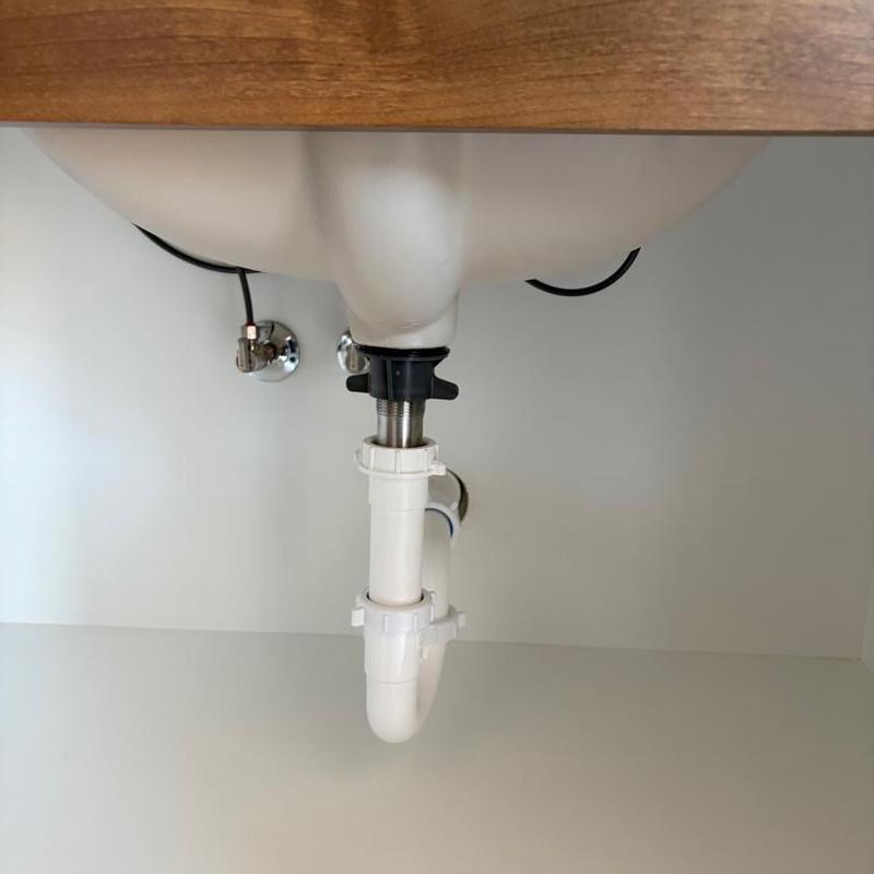 Sink drain pipe and plumbing connections under countertop