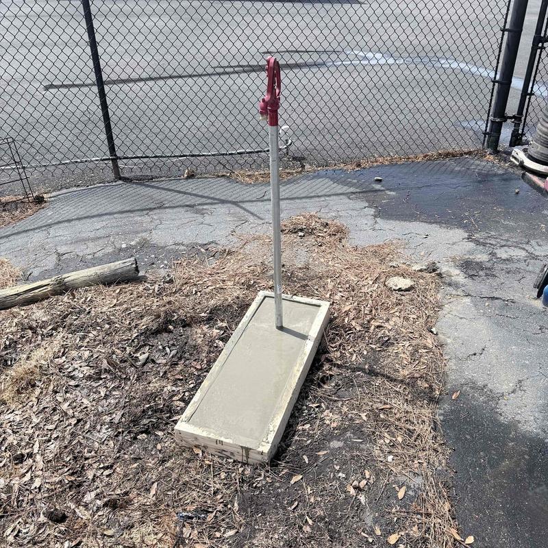 Outdoor water spigot with new concrete pad installation