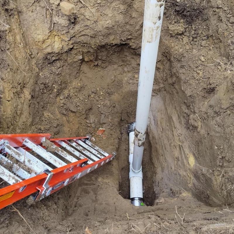 6-inch sewer pipe installation in ground trench with ladder