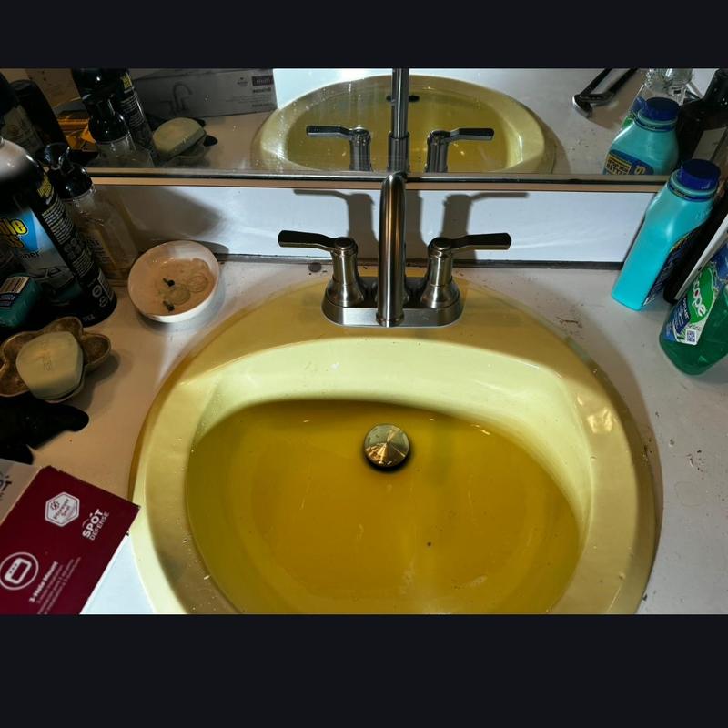 Bathroom sink faucet with dual handles and yellow basin