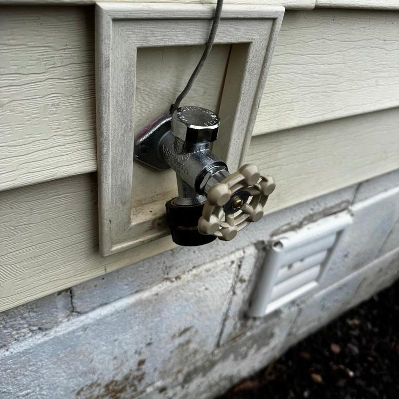 Hose bib valve installed on exterior house wall
