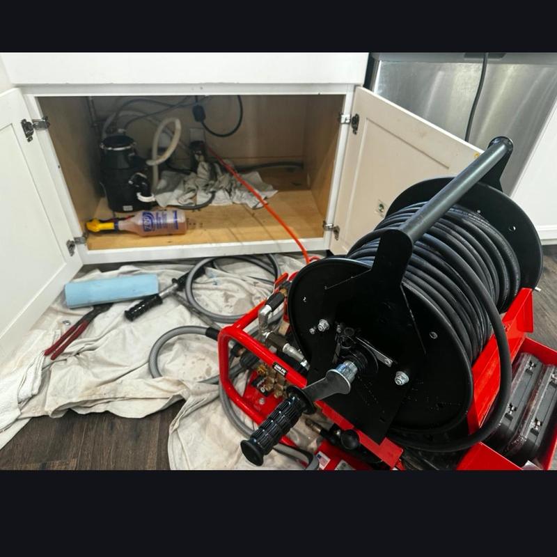 Kitchen drain line hydro jetting with hose reel equipment