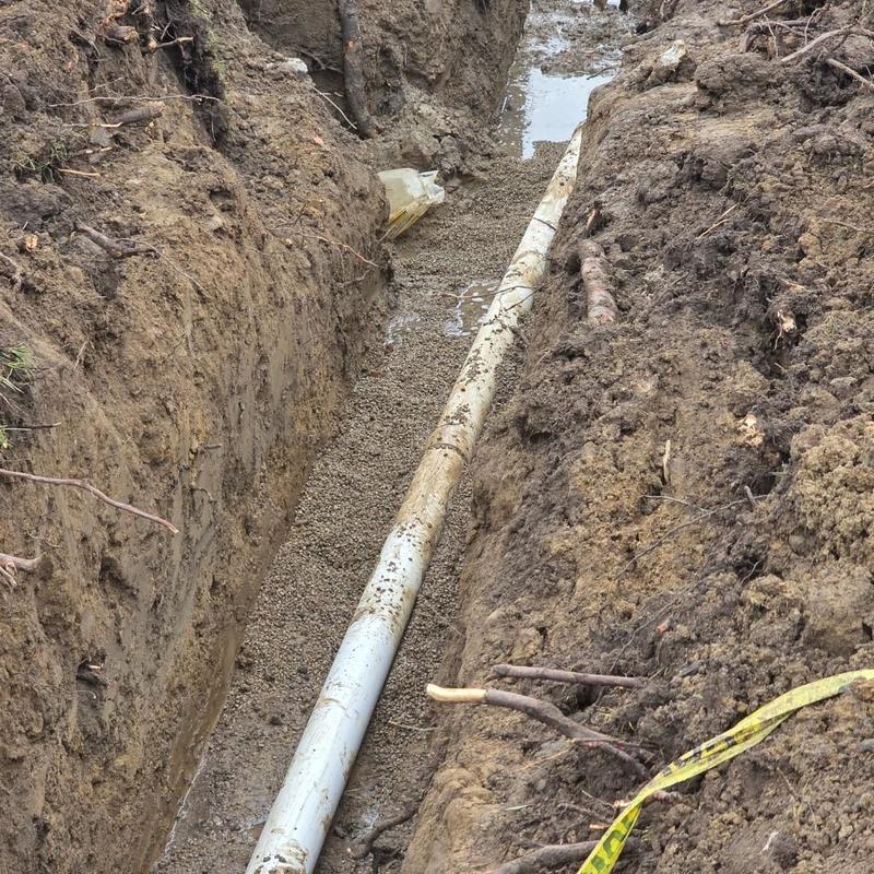 4-inch PVC septic bypass pipe installation in trench
