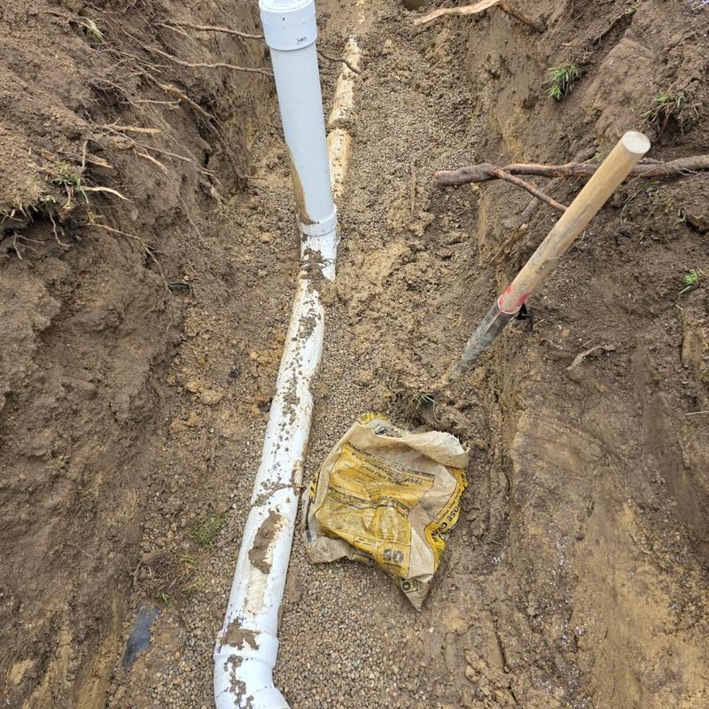 4-inch PVC septic bypass pipe installation in trench