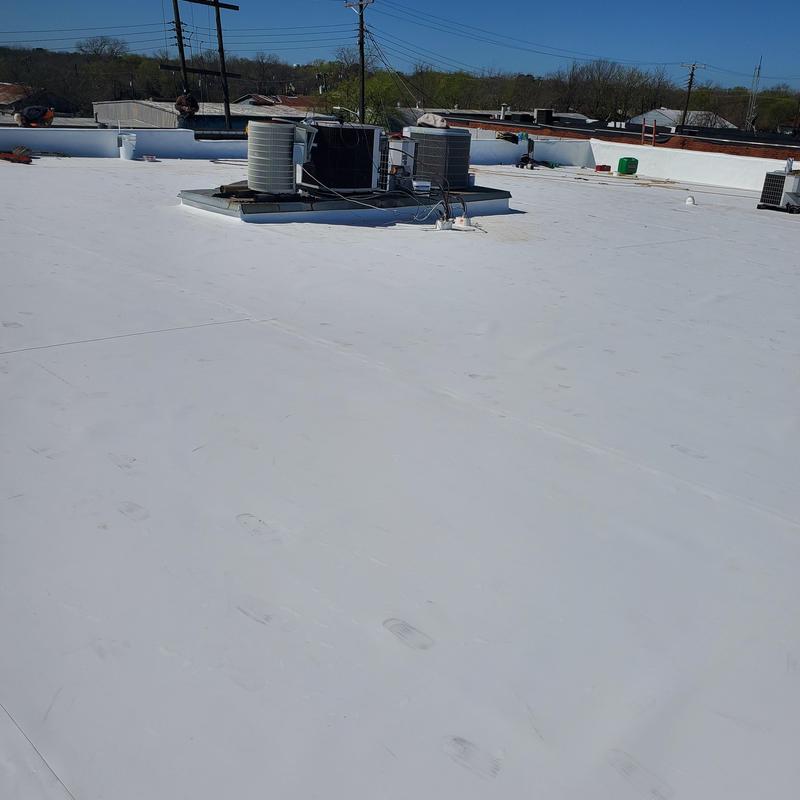 White flat roof membrane with rooftop HVAC units