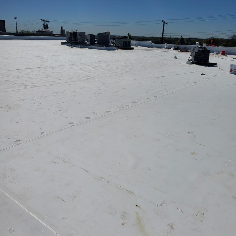 TPO flat roof with HVAC units after storm damage