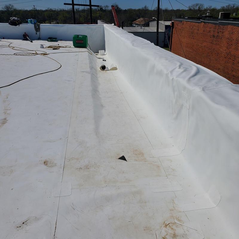 TPO flat roof membrane installation on commercial building