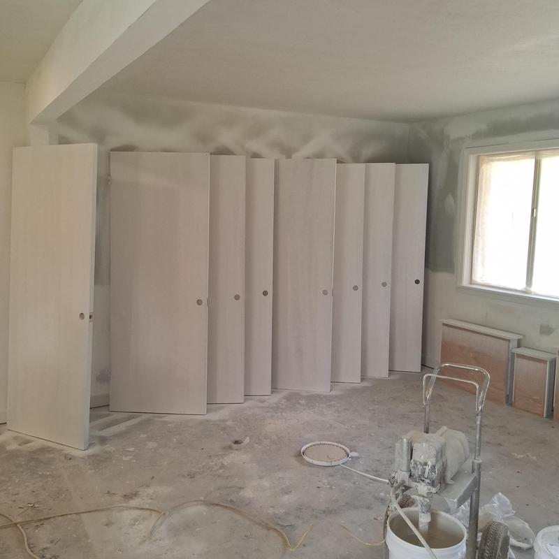 Interior doors staged for painting in remodel room