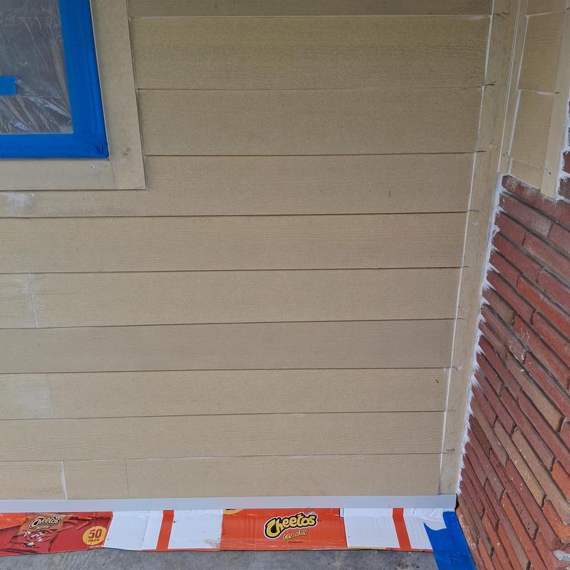 Exterior siding with protective paint and masking tape