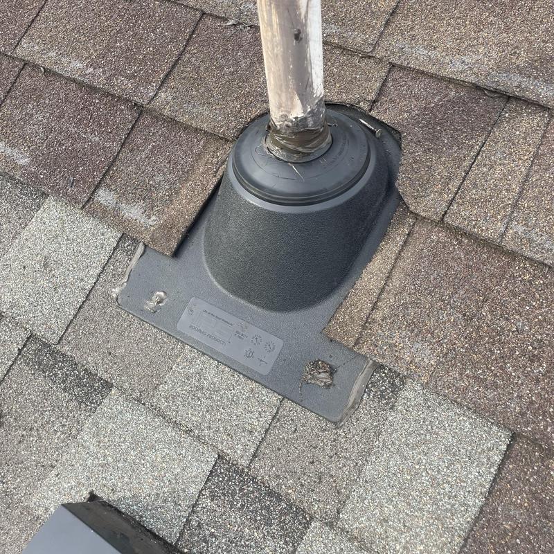 Roof vent flashing with sealed pipe penetration on shingles