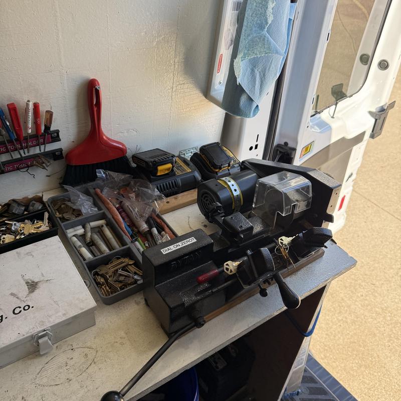 Key duplicating machine with keys and tools on workbench