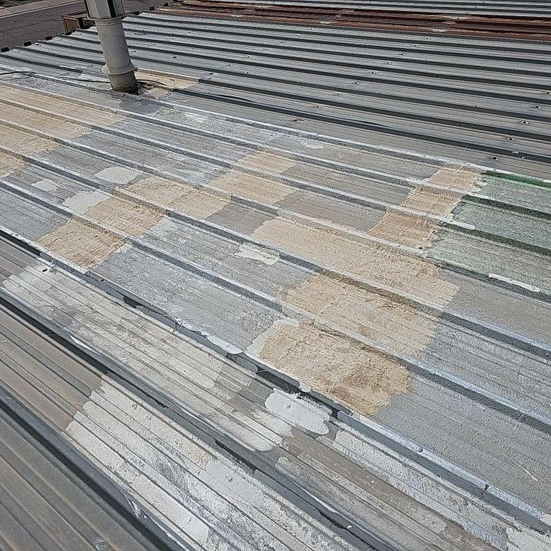 Metal roof screws with rust patches and sealant application