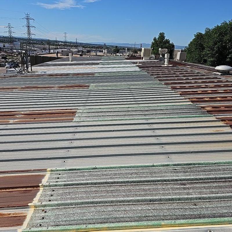 Metal roof with rust and dislodged screws