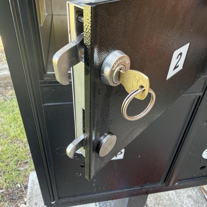 Mailbox lock cylinder with key in black metal unit