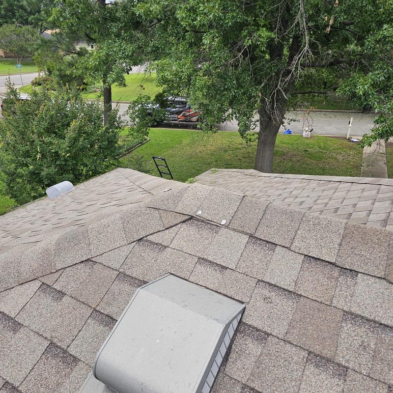 Asphalt shingle roof with visible hail damage spots