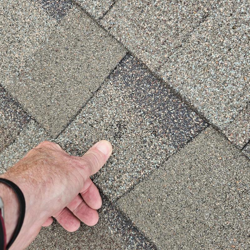Asphalt shingle roof with hail damage inspection