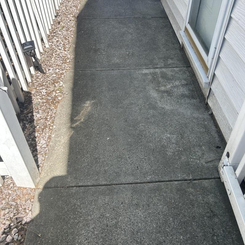 Sewer cleanout cap near concrete walkway and fence Sewer cleanout cap near concrete walkway and fence