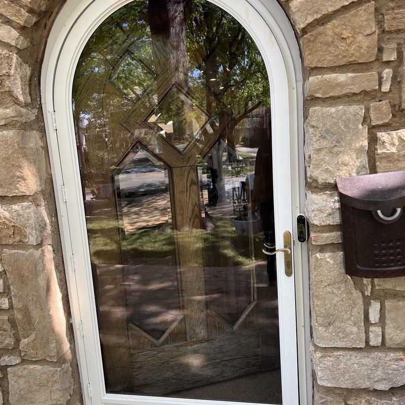 Storm door lock and strike adjustment on stone exterior