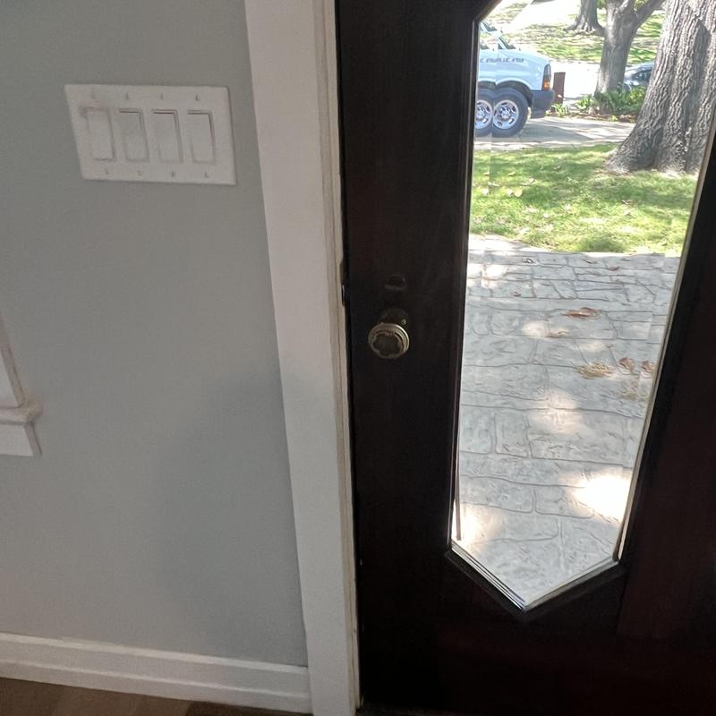 Storm door lock and strike adjustment near light switches